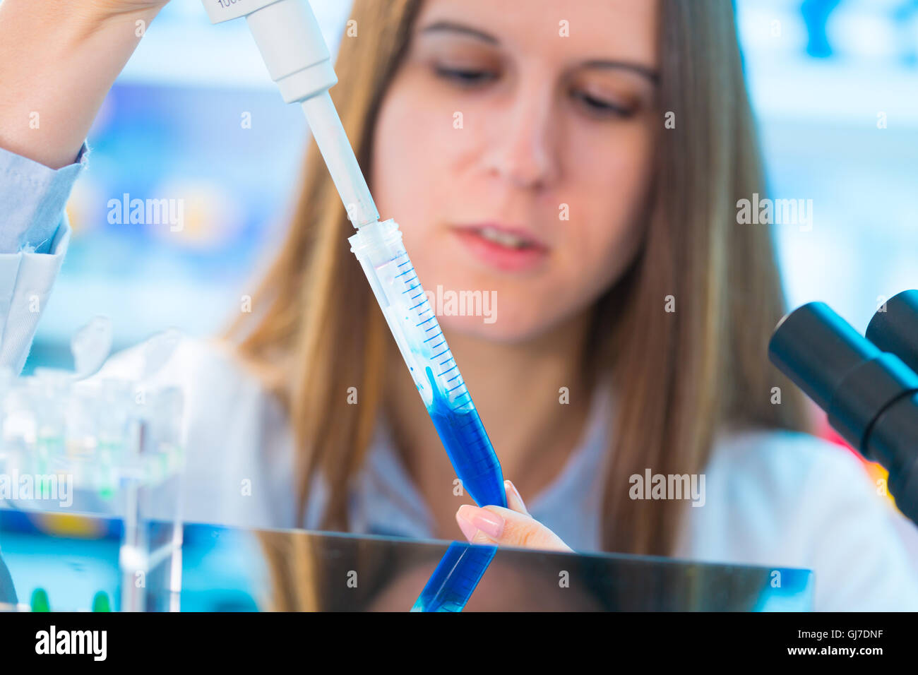 Quality control of food products. Young woman in chemical laboratory ...