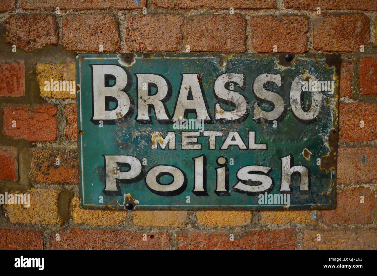 Vejle, Denmark - November 12, 2015: Old style tin advertising board for Brasso  metal polish displayed on