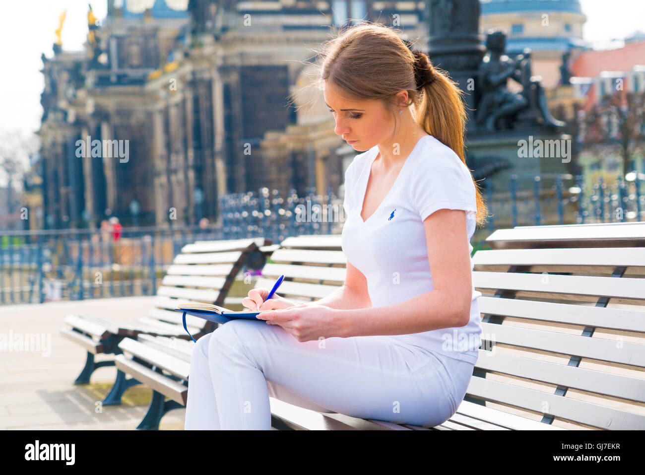 Woman tourist writes his impressions in a diary, Dresden, Germany Stock Photo