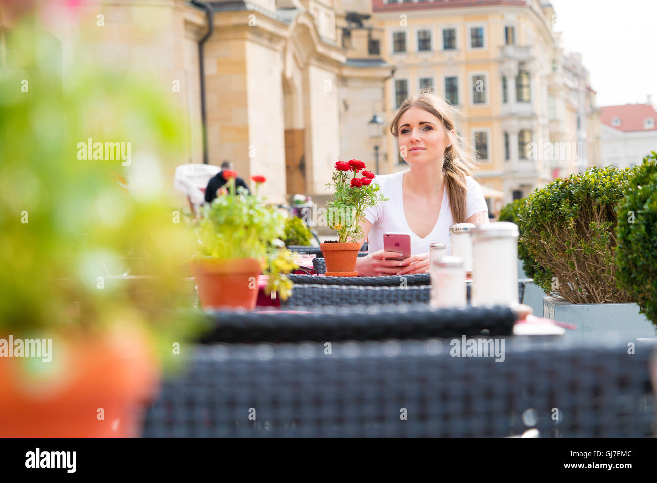 Woman drinking cappuccino at an outdoor cafe Stock Photo