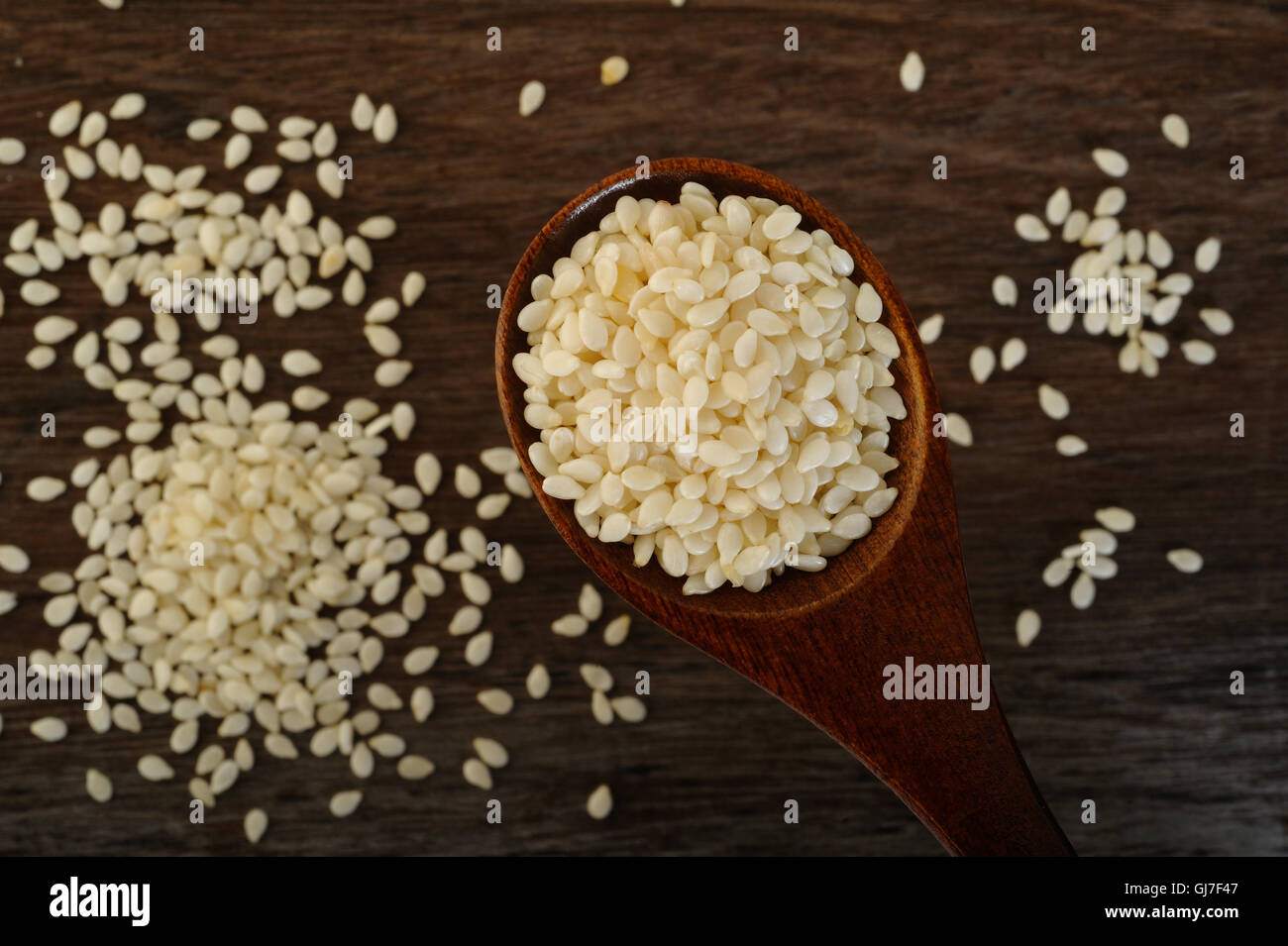 white sesame seeds in wooden spoon Stock Photo