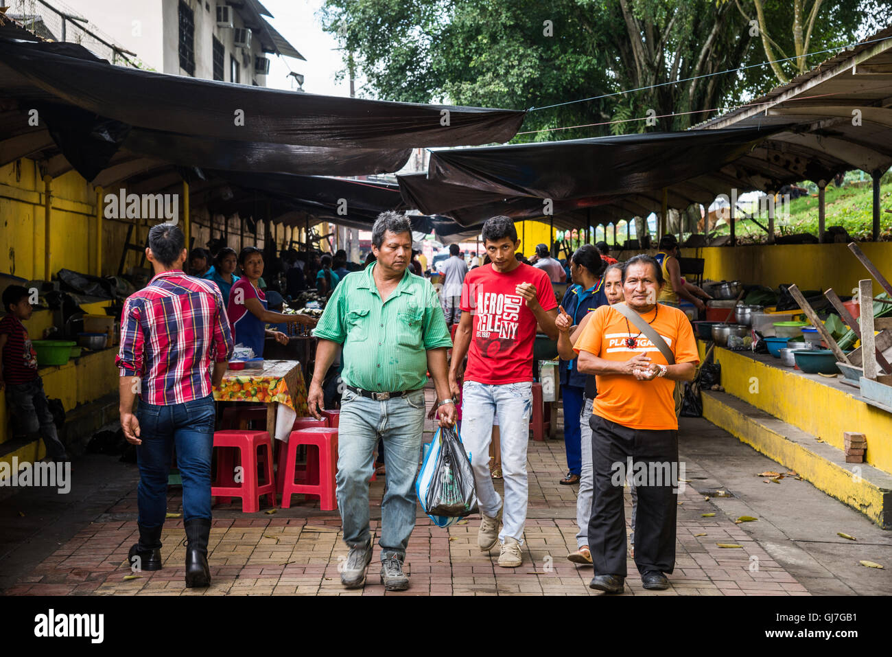 Local people walking at a street market in Coca,  the gateway city to the Amazons, Ecuador, South America. Stock Photo