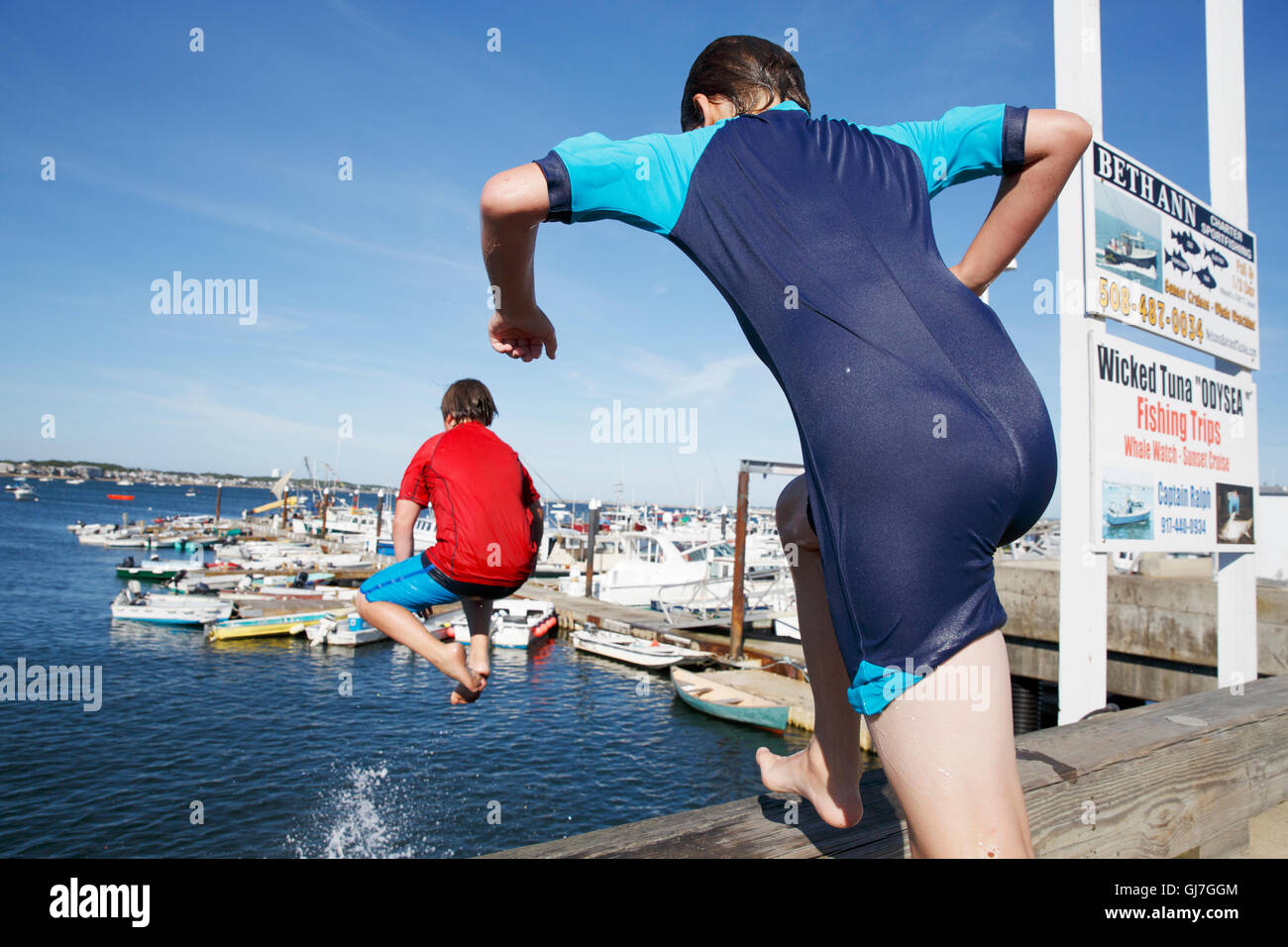 Teenagers jumping off MacMillan Wharf, Provincetown, Cape Cod, Massachusetts Stock Photo