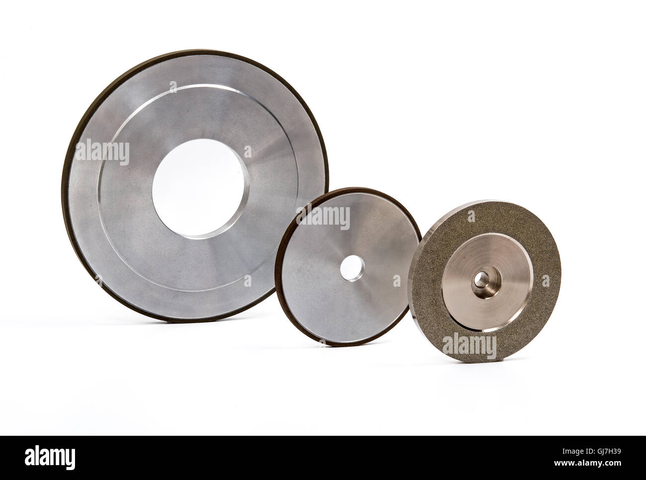Industrial grinding and polishing wheels on white background Stock