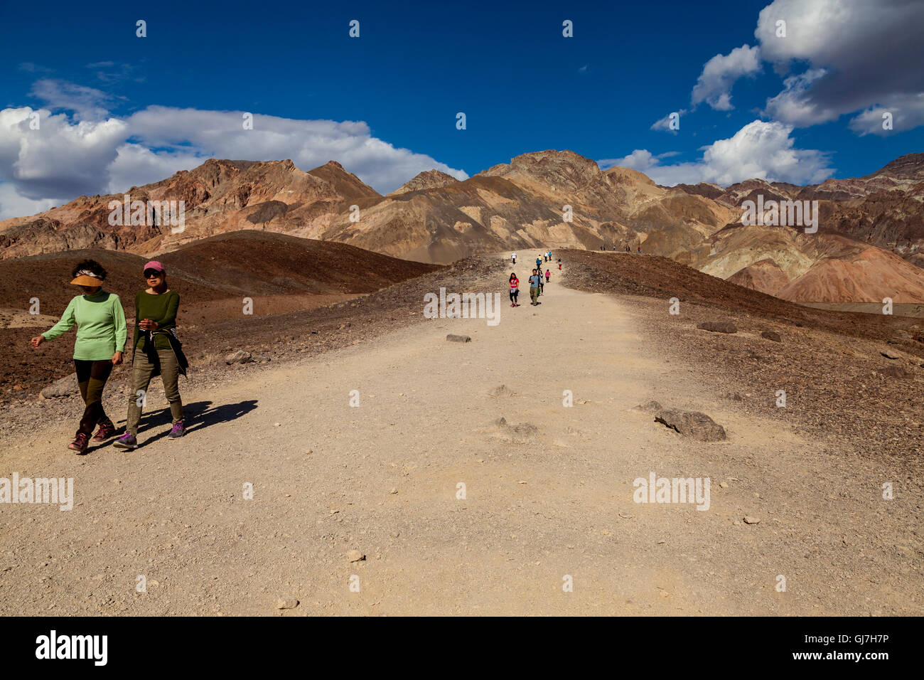 Tourists Hiking On The Volcanic And Sedimentary Hills Near
