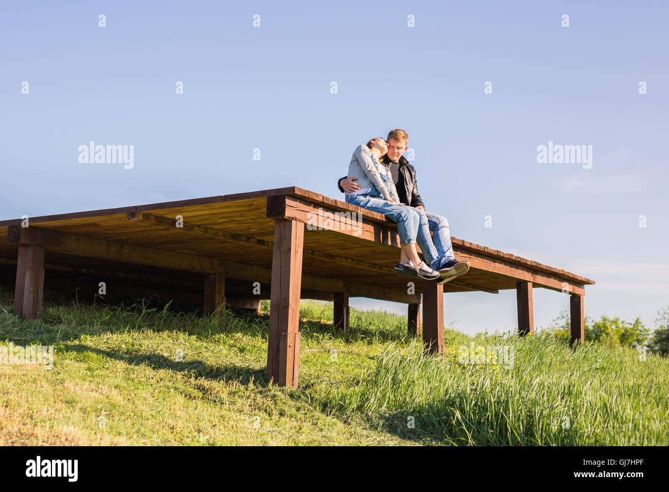Happy pregnant woman and her husband in the park Stock Photo - Alamy