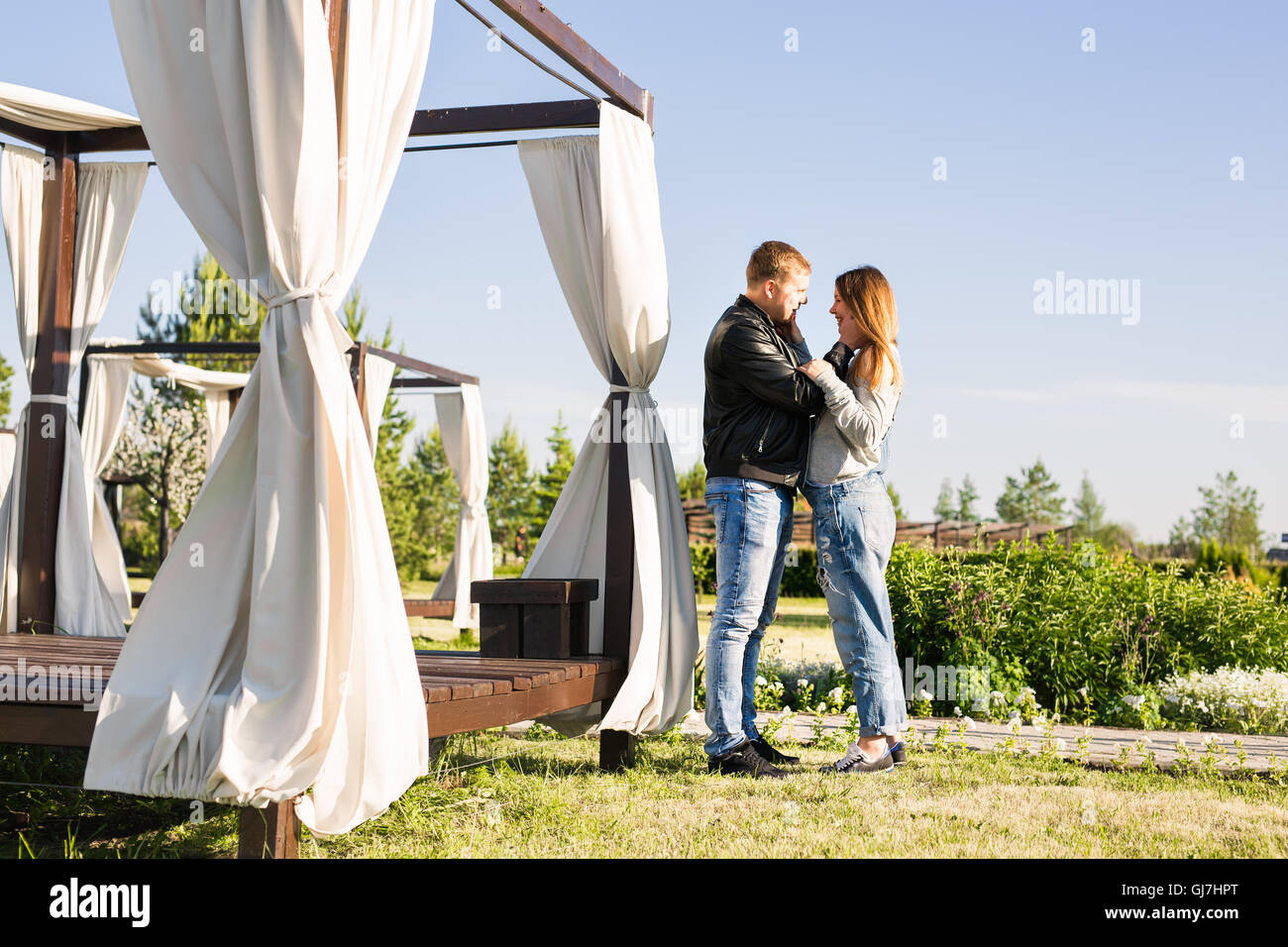 Happy pregnant woman and her husband in the park Stock Photo - Alamy