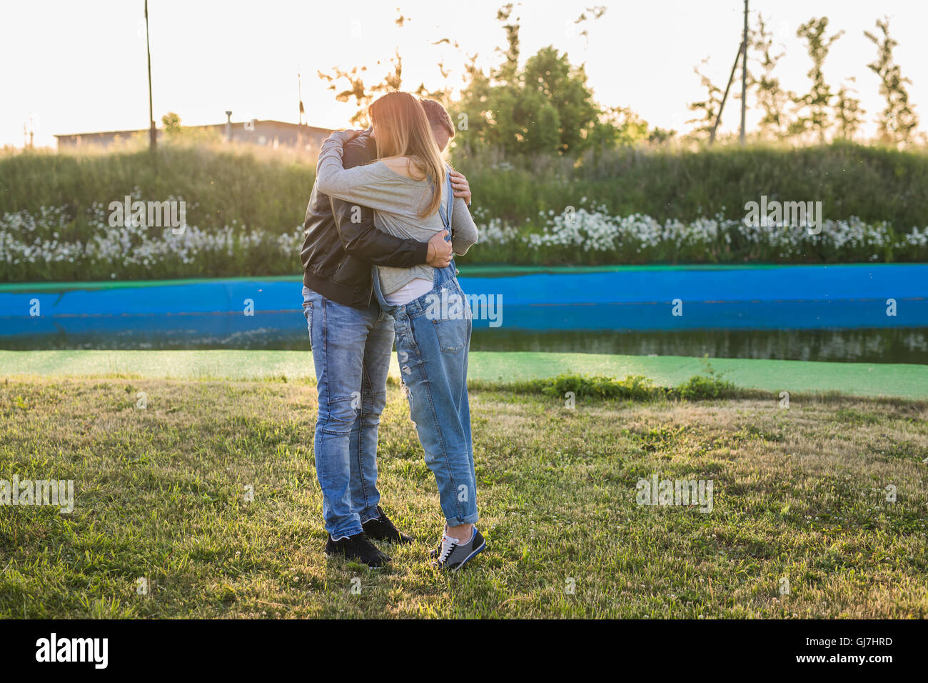 Happy pregnant woman and her husband in the park Stock Photo - Alamy