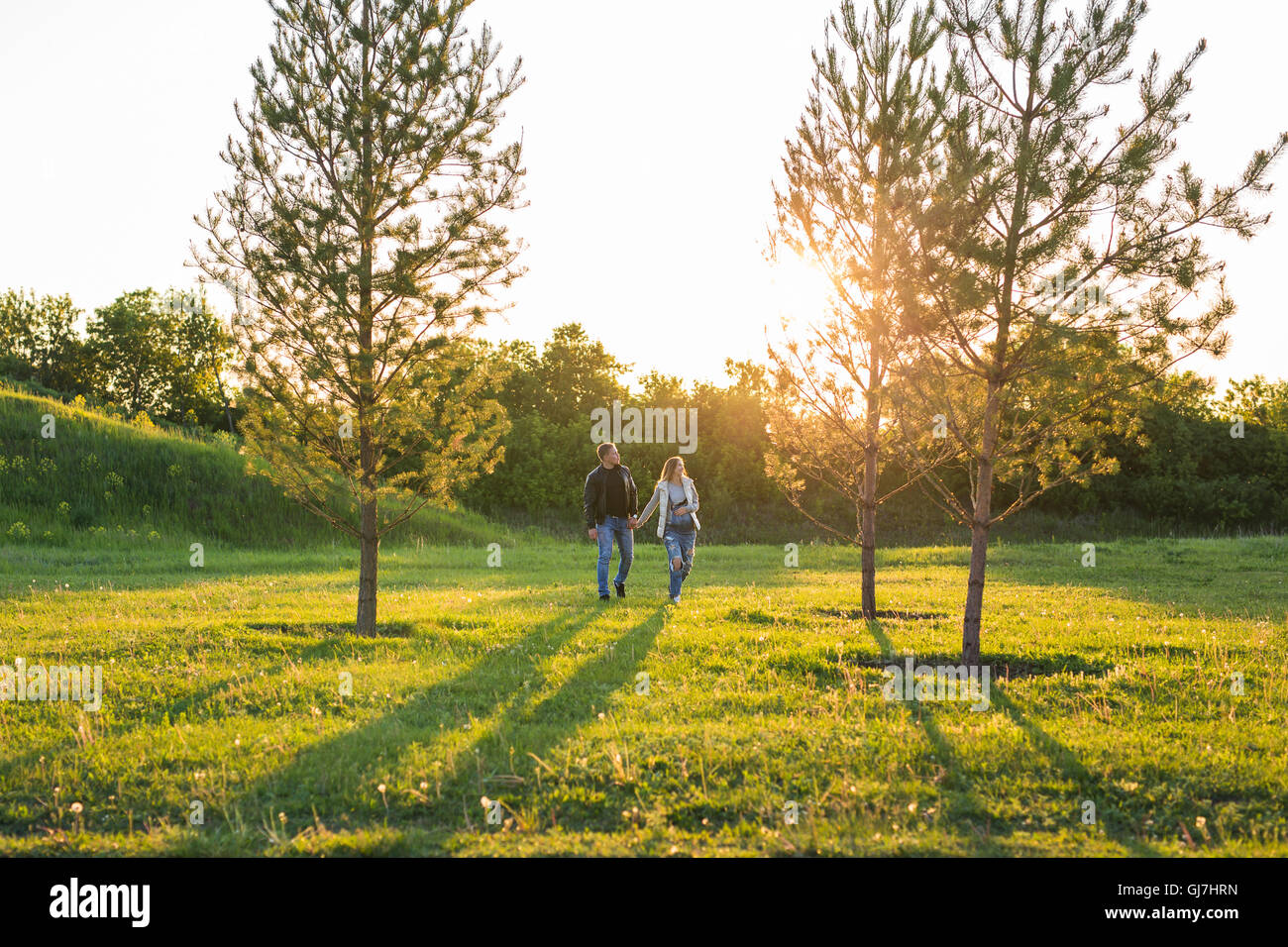 Happy pregnant woman and her husband in the park Stock Photo - Alamy