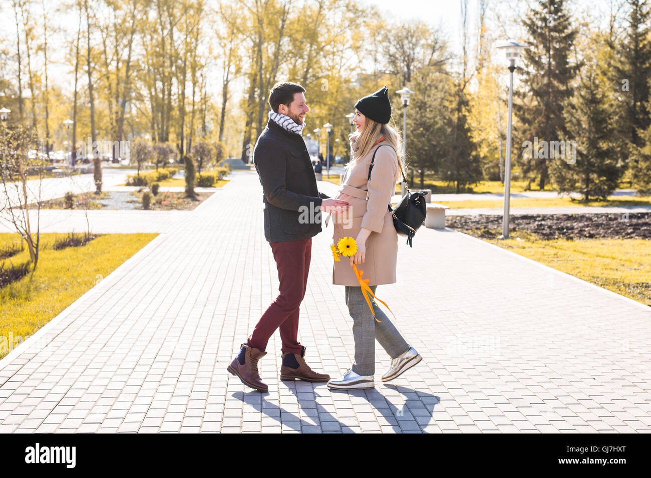 Happy pregnant woman and her husband in the park Stock Photo - Alamy