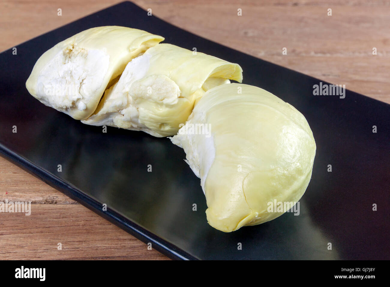 King of fruits, durian on a black dish and wood table Stock Photo - Alamy
