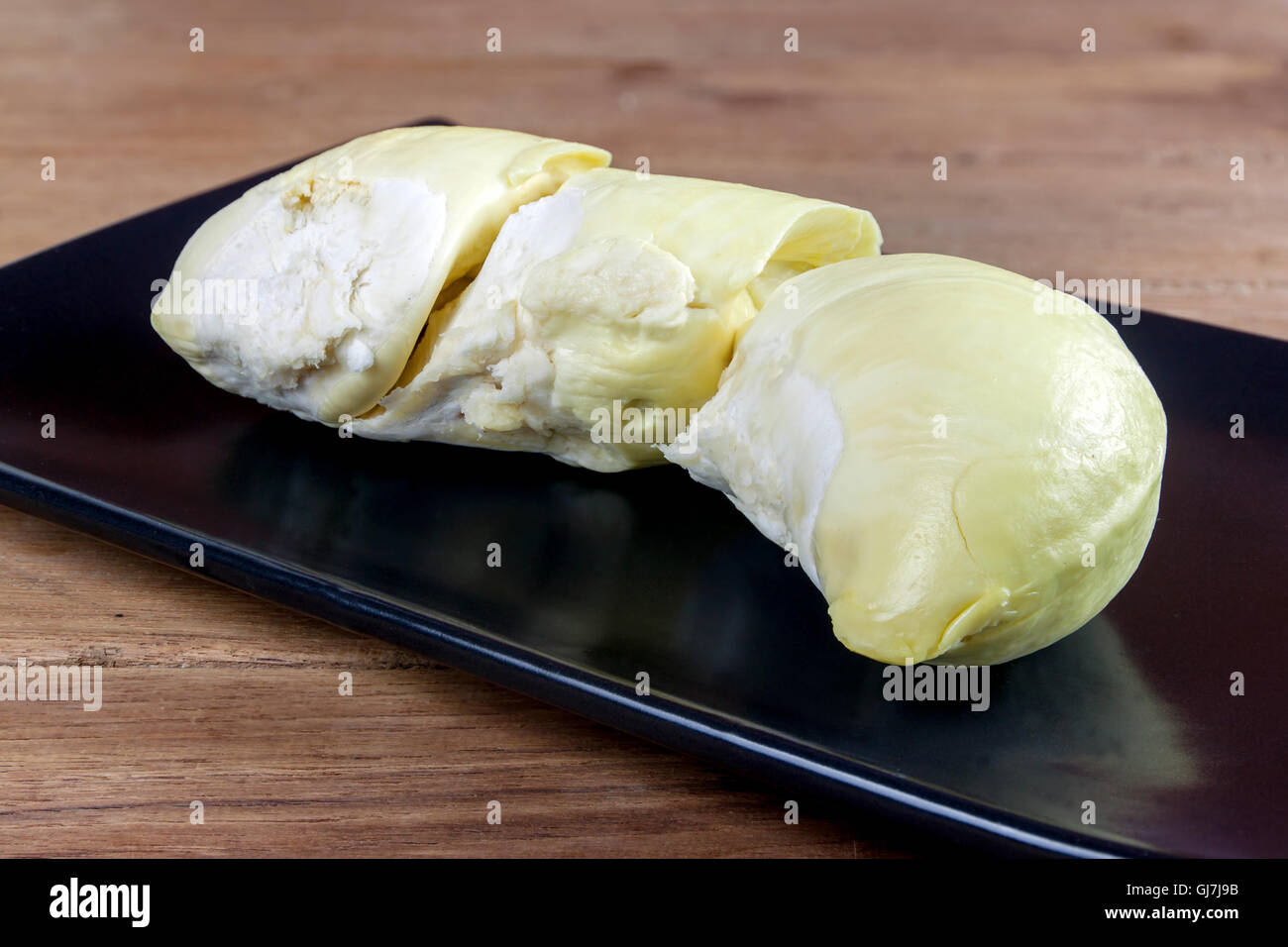 King of fruits, durian on a black dish and wood table Stock Photo - Alamy