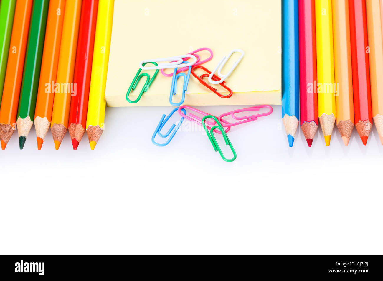 set of colored pencils and paper clips on a white background Stock Photo Alamy