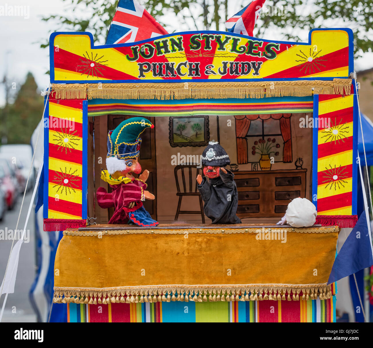 Mr Punch and Mr Policemen puppets at a Punch and Judy puppet booth Stock Photo