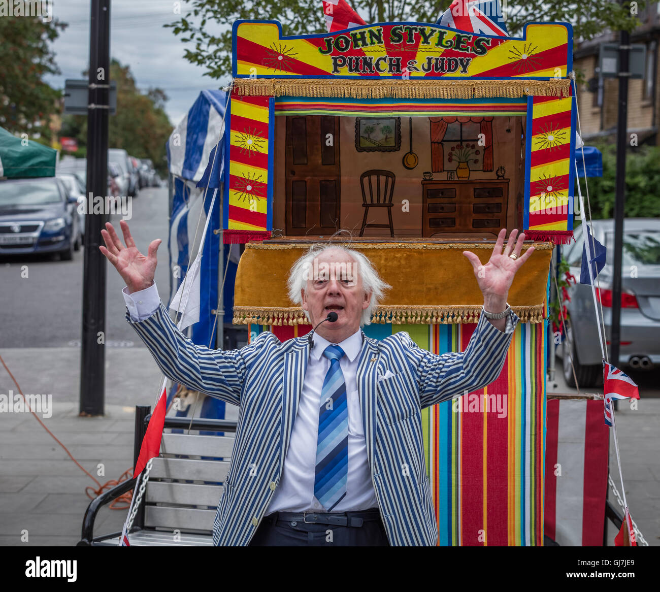 Professor John Styles Punch and Judy puppeteer stands in front of his