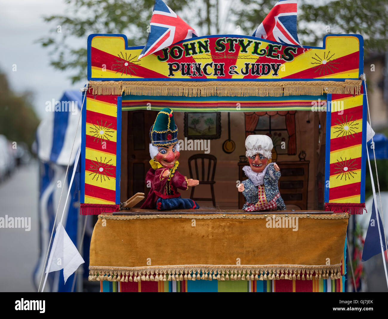 Mr Punch and Judy in front of a Punch and Judy glove puppet booth with