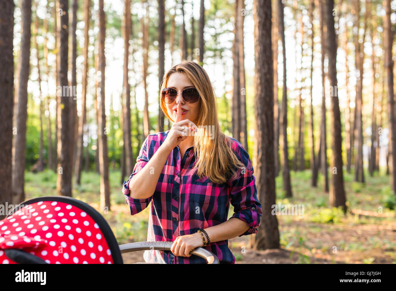 young woman with finger on lips Stock Photo - Alamy