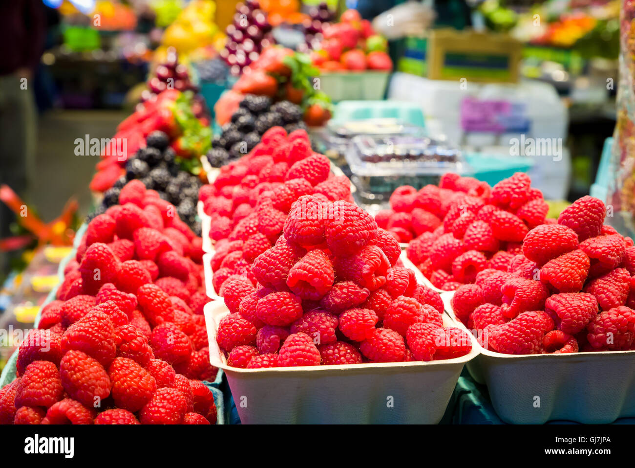 Containers of fresh raspberries on display in a Canadian grocery store
