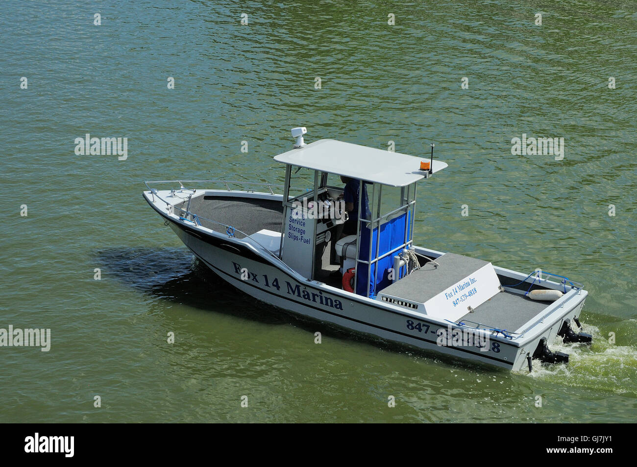 Marina tow boat cruising the Fox River in Northern Illinois, USA. Stock Photo