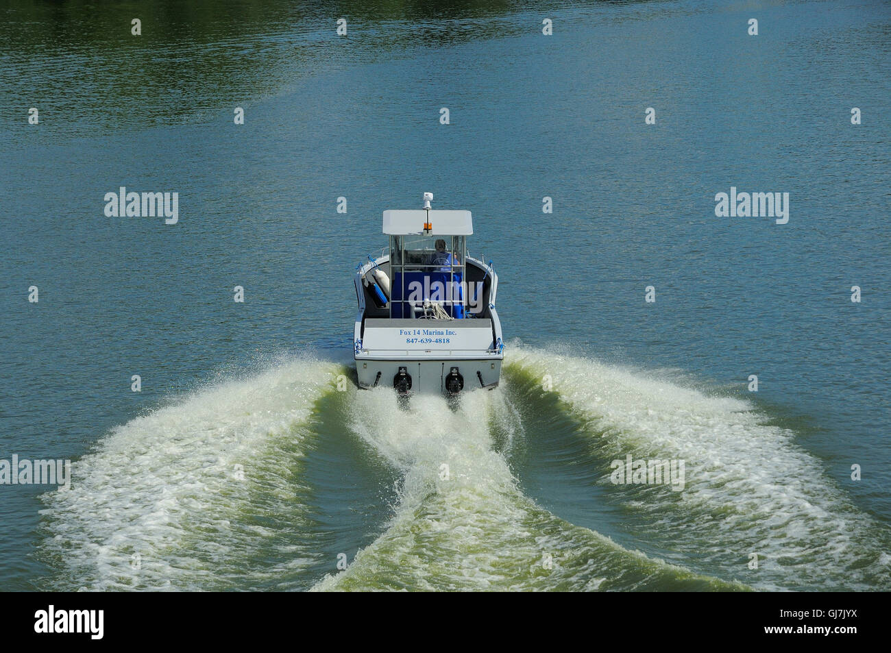 Marina tow boat cruising the Fox River in Northern Illinois, USA. Stock Photo
