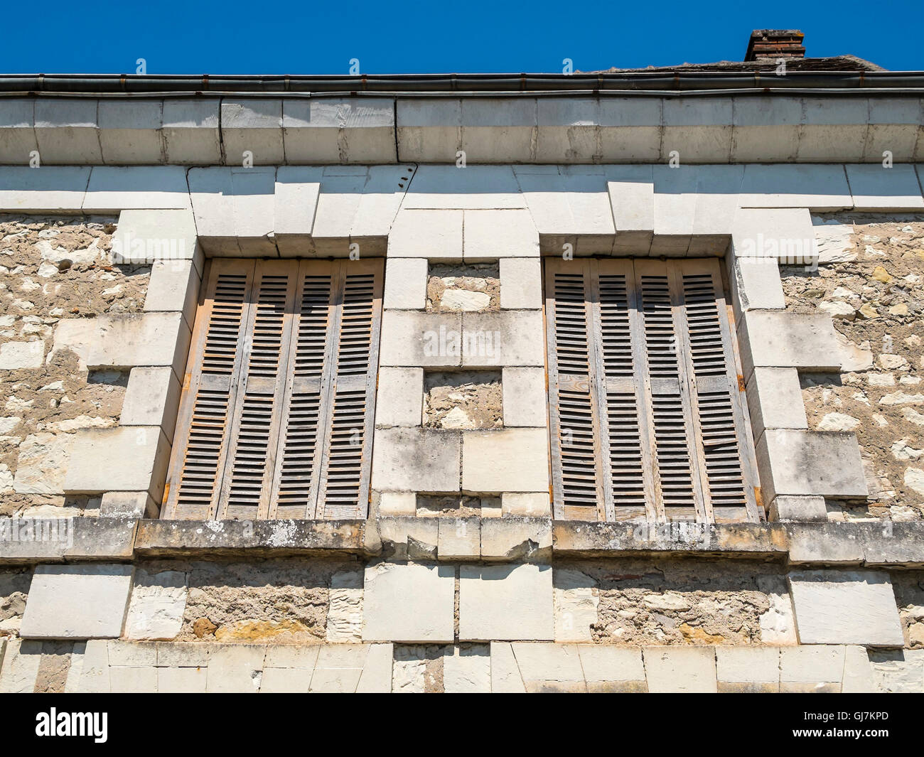 Old window shutters in terrace of stone houses - France. Stock Photo