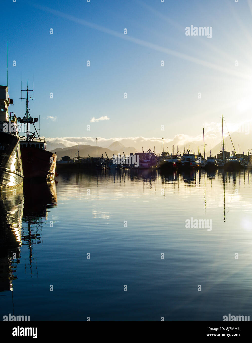 Fishing vessels are moored in the flat protected water of the Homer small boat harbor in Alaska. Stock Photo