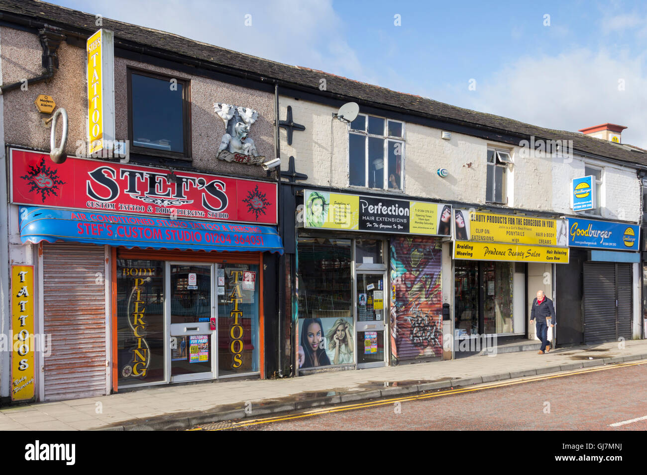 Shops on Newport Street, on the fringe of Bolton town centre, mostly specialising in aspects of the cosmetic body image trade. Stock Photo