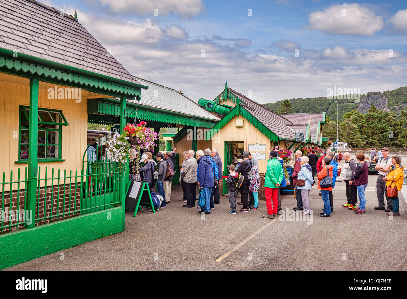 Queue of people in outdoor gear at Llanberis Station, waiting for the Snowdon Mountain Railway, Llanberis, Snowdonia National... Stock Photo