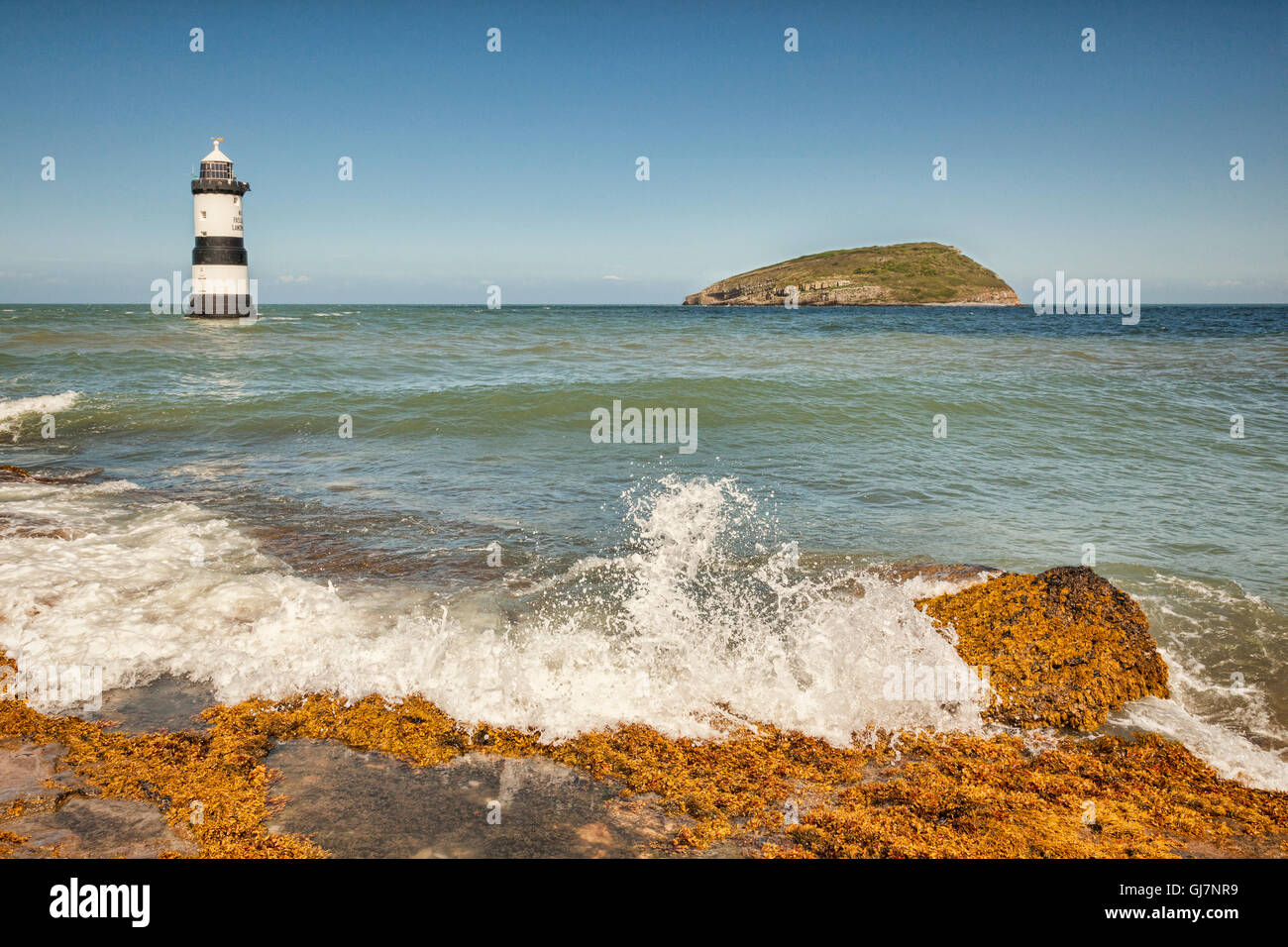 Penmon Lighthouse and Puffin Island, off Penmon Point, at the east end of the Menai Strait, Anglesey, Wales, UK. Stock Photo