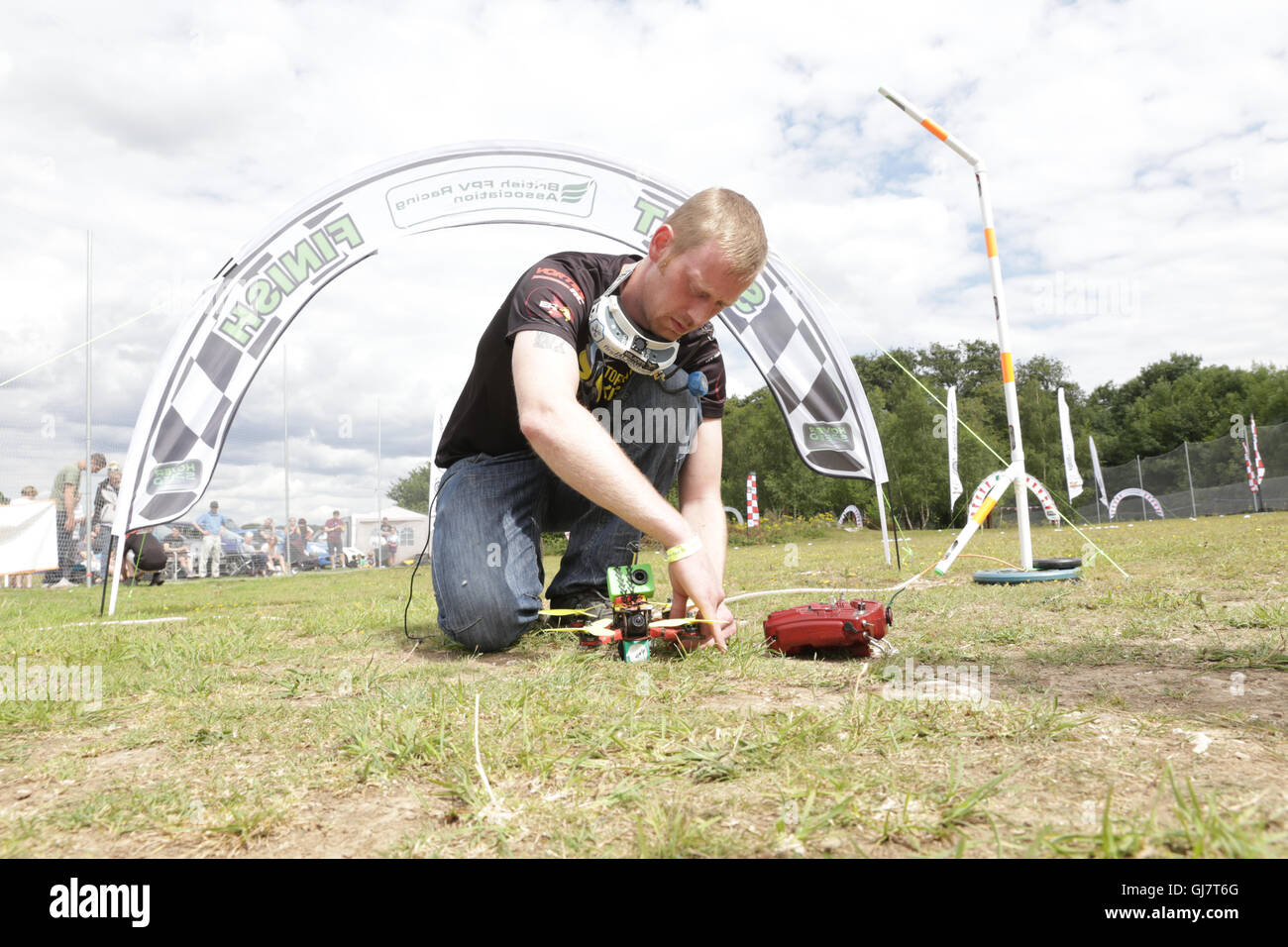 Drone Racing Queen's Cup 2016.  James Bowles aka Jab1a places a drone at thestart line prior to a race. Stock Photo