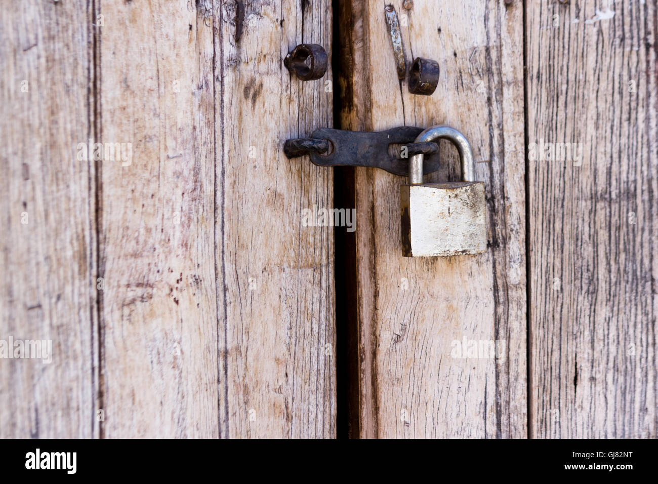 close up of an old wooden door with a newer lock Stock Photo - Alamy
