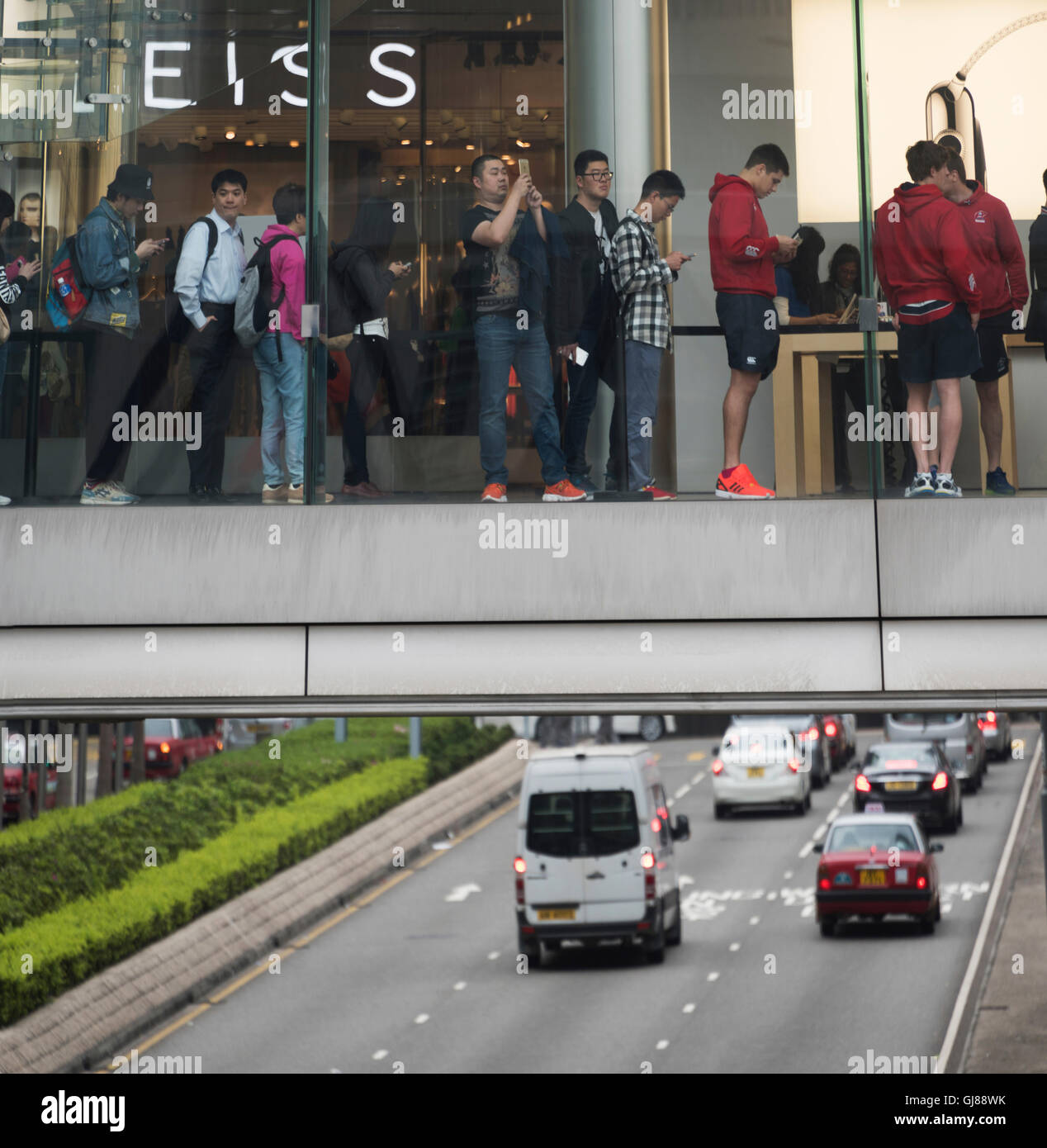 A suspended corridor leading to the Apple store high above a main road in Hong Kong. Stock Photo