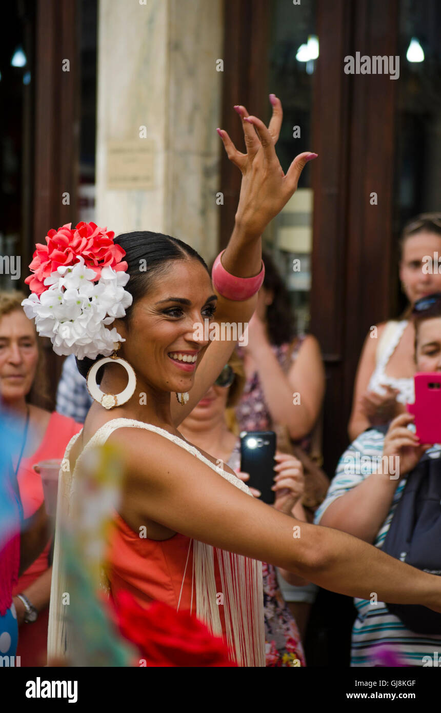 Malaga, Andalusia, Spain. 13th Aug, 2016. Malaga, Andalusia, Spain, 13 August 2016. Beautiful spanish woman dressed in flamenco dress, dancing Sevillanas, during start of Annual Feria of Malaga, Southern Spain's biggest summer fair starts. The feria celebrations. Credit:  Perry van Munster/Alamy Live News Stock Photo