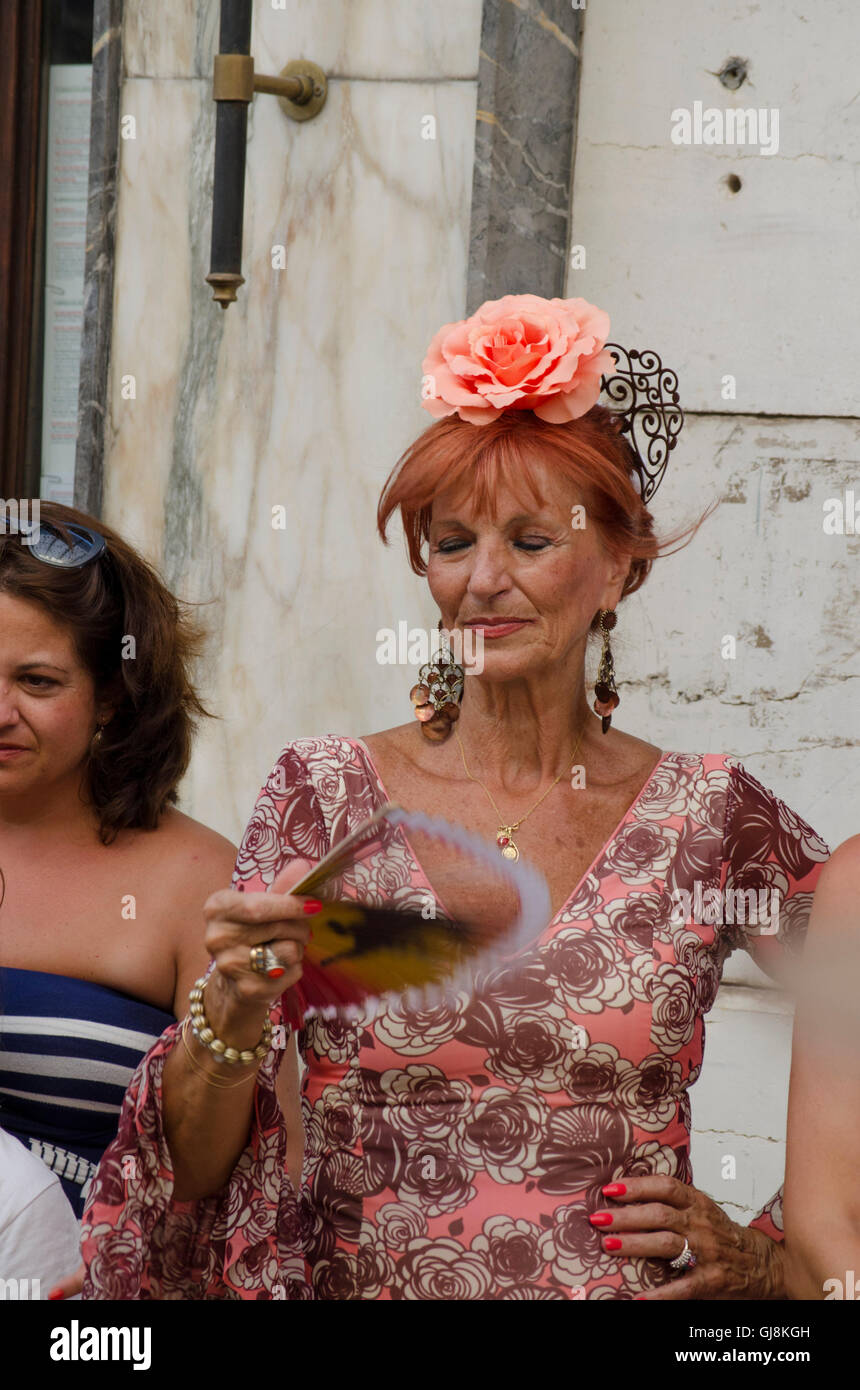 Malaga, Andalusia, Spain. 13th Aug, 2016. Woman dressed in flamenco dress during start of Annual Feria of Malaga, Southern Spain's biggest summer fair starts. The feria celebrations. Credit:  Perry van Munster/Alamy Live News Stock Photo