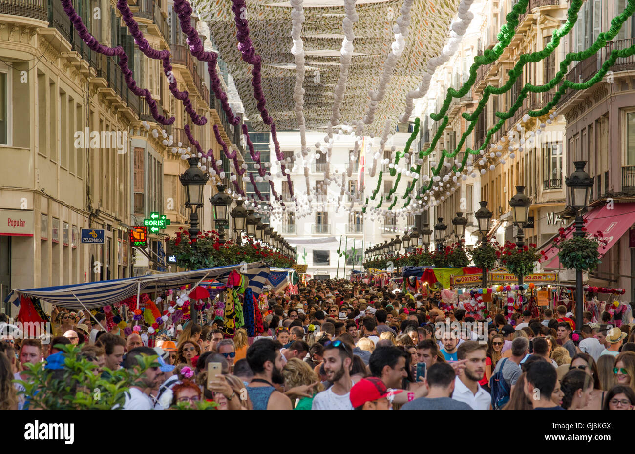 Malaga, Andalusia, Spain. 13th Aug, 2016. Crowd at Calle Larios, main street, celebrating start of Annual Feria of Malaga, Southern Spain's biggest summer fair starts. The feria celebrations. Credit:  Perry van Munster/Alamy Live News Stock Photo