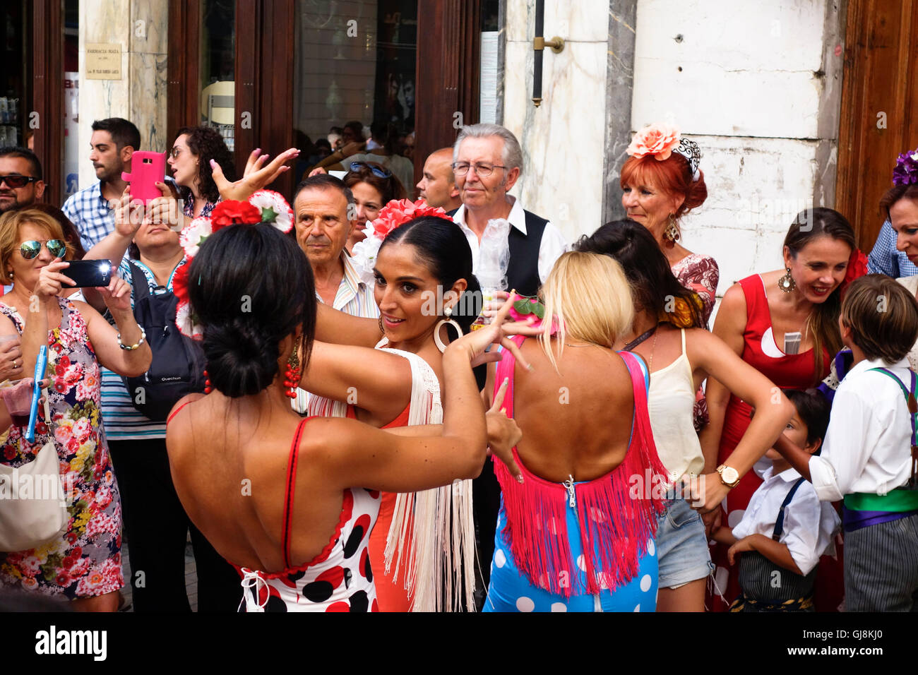 Malaga, Andalusia, Spain. 13th Aug, 2016. Beautiful women dressed in flamenco dresses dancing Sevillanas, during start of Annual Feria of Malaga, Southern Spain's biggest summer fair starts. The feria celebrations. Credit:  Perry van Munster/Alamy Live News Stock Photo