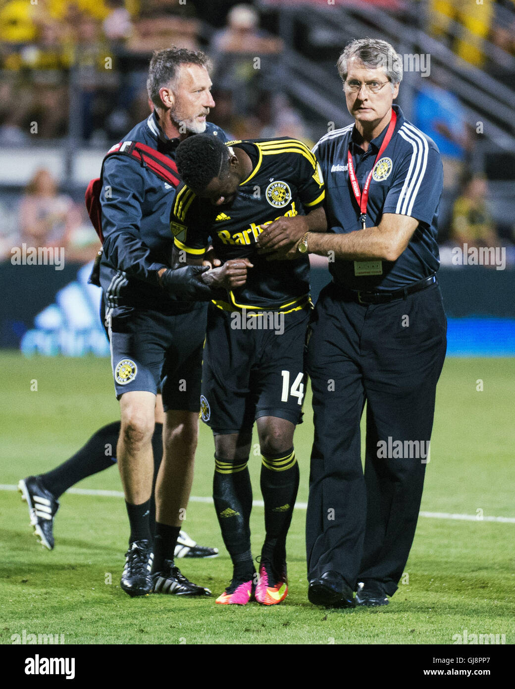 Columbus, U.S.A. 13th Aug, 2016. August 13, 2016: Columbus Crew SC defender Waylon Francis (14) is helped off the pitch after suffering a shoulder injury in the second half against New York FC. Columbus, OH, USA. (Brent Clark/Alamy Live News) Stock Photo