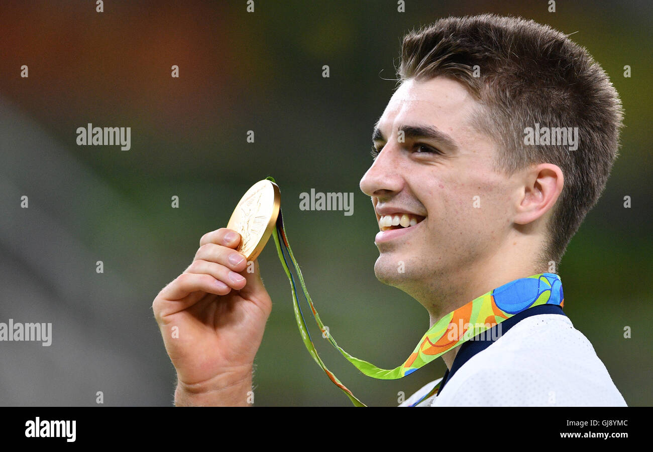 Rio de Janeiro, Brazil. 14th Aug, 2016. Gold medalist Max Whitlock of Great Britain celebrates during the medal ceremony of the Men's Floor Exercise Final during the Artistic Gymnastics events of the Rio 2016 Olympic Games at the Rio Olympic Arena in Rio de Janeiro, Brazil, 14 August 2016. Photo: Lukas Schulze/dpa/Alamy Live News Stock Photo