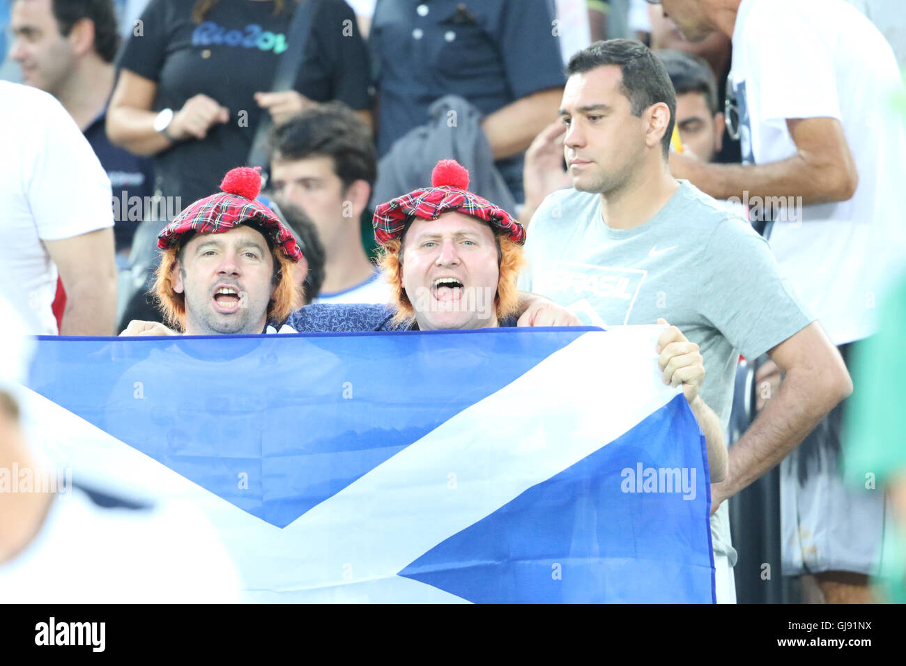 Rio de Janeiro, Brazil. 14th Aug, 2016. Excited Murray supporters waving the Scottish Saltire flag as Murray wins a point in the Olympic mens singles final in Rio de Janeiro, Brazil Credit:  PictureScotland/Alamy Live News Stock Photo