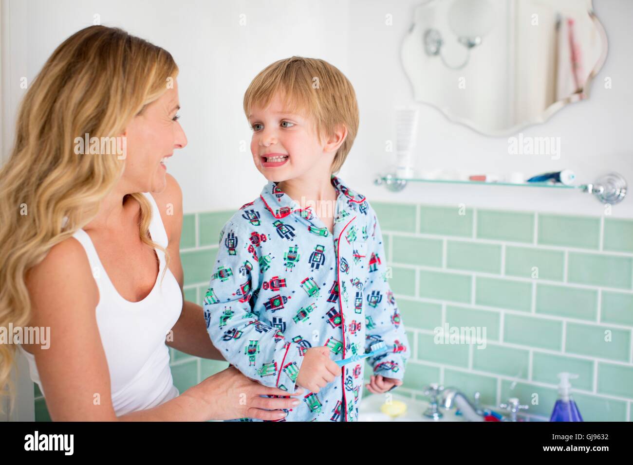 PROPERTY RELEASED. MODEL RELEASED. Mother and son in bathroom brushing teeth. Stock Photo