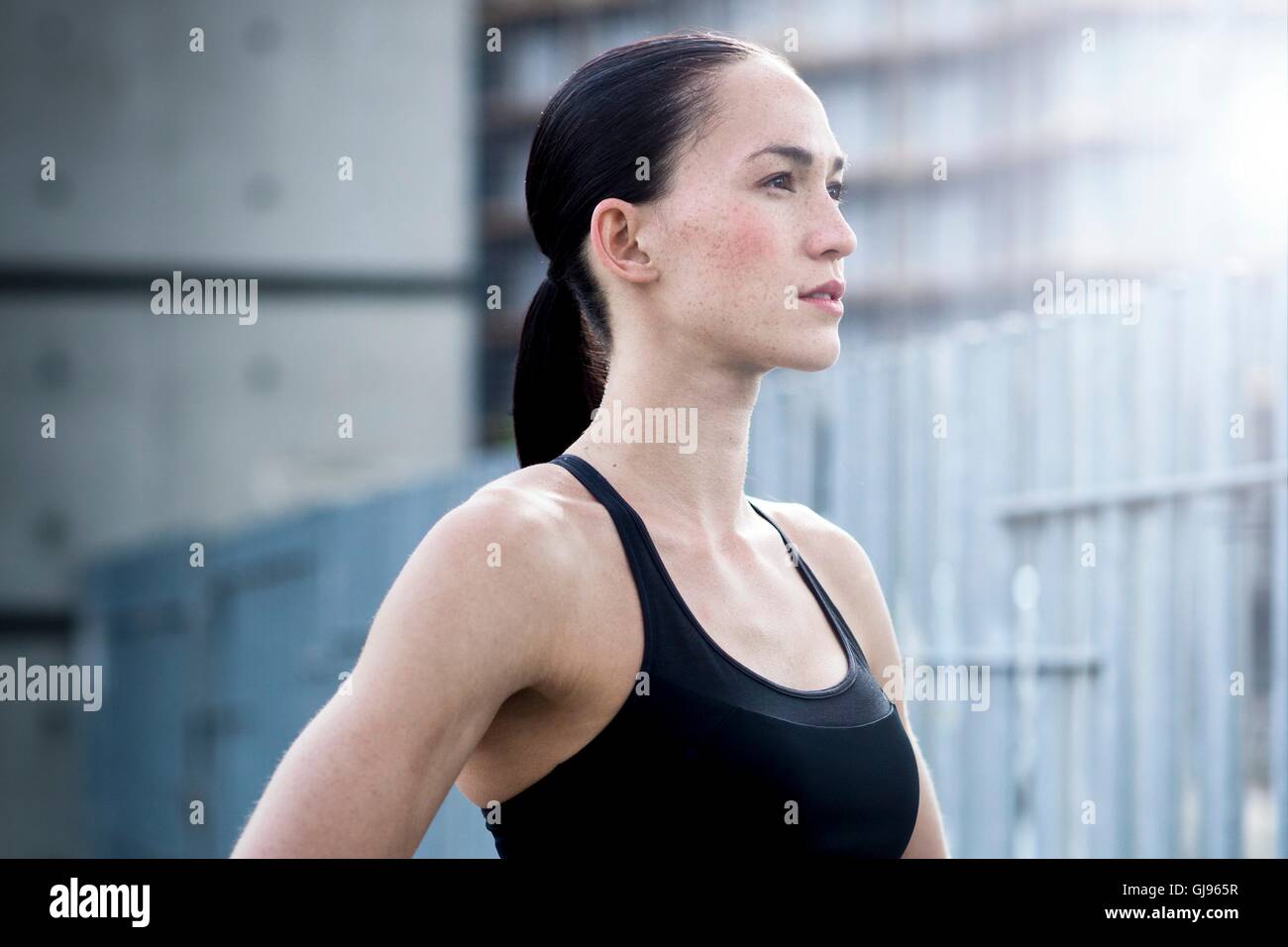 MODEL RELEASED. Young woman in crop top looking away. Stock Photo