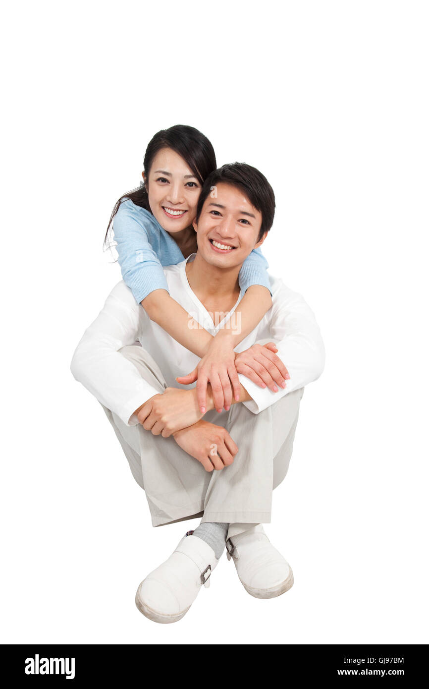 Casual couple sitting studio shot Stock Photo - Alamy