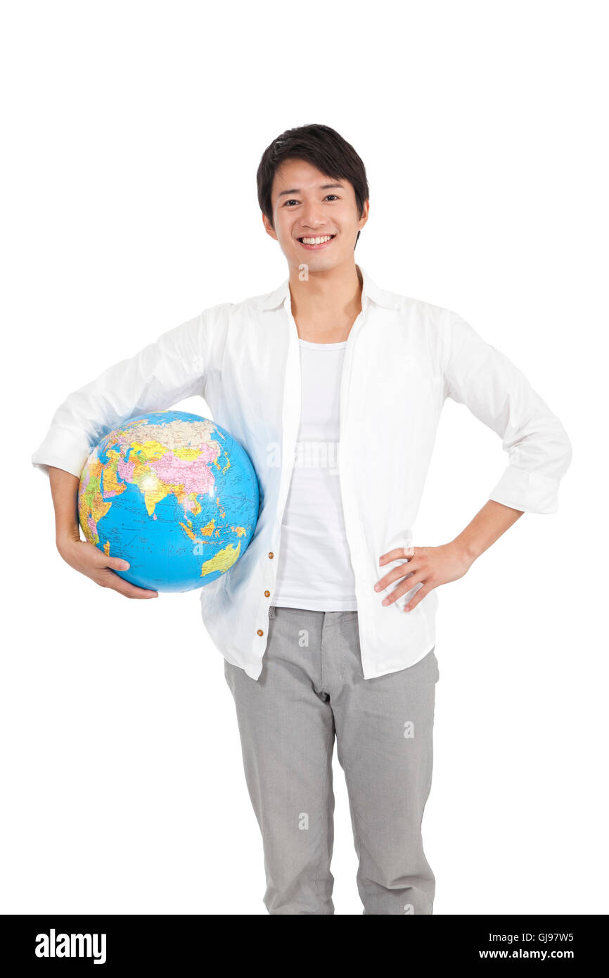 Studio shot of young casual man holding a globe Stock Photo - Alamy