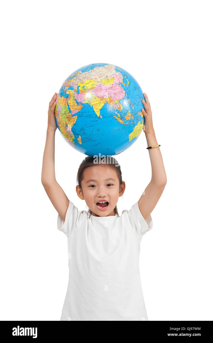 Studio shot little girl holding globe Stock Photo - Alamy