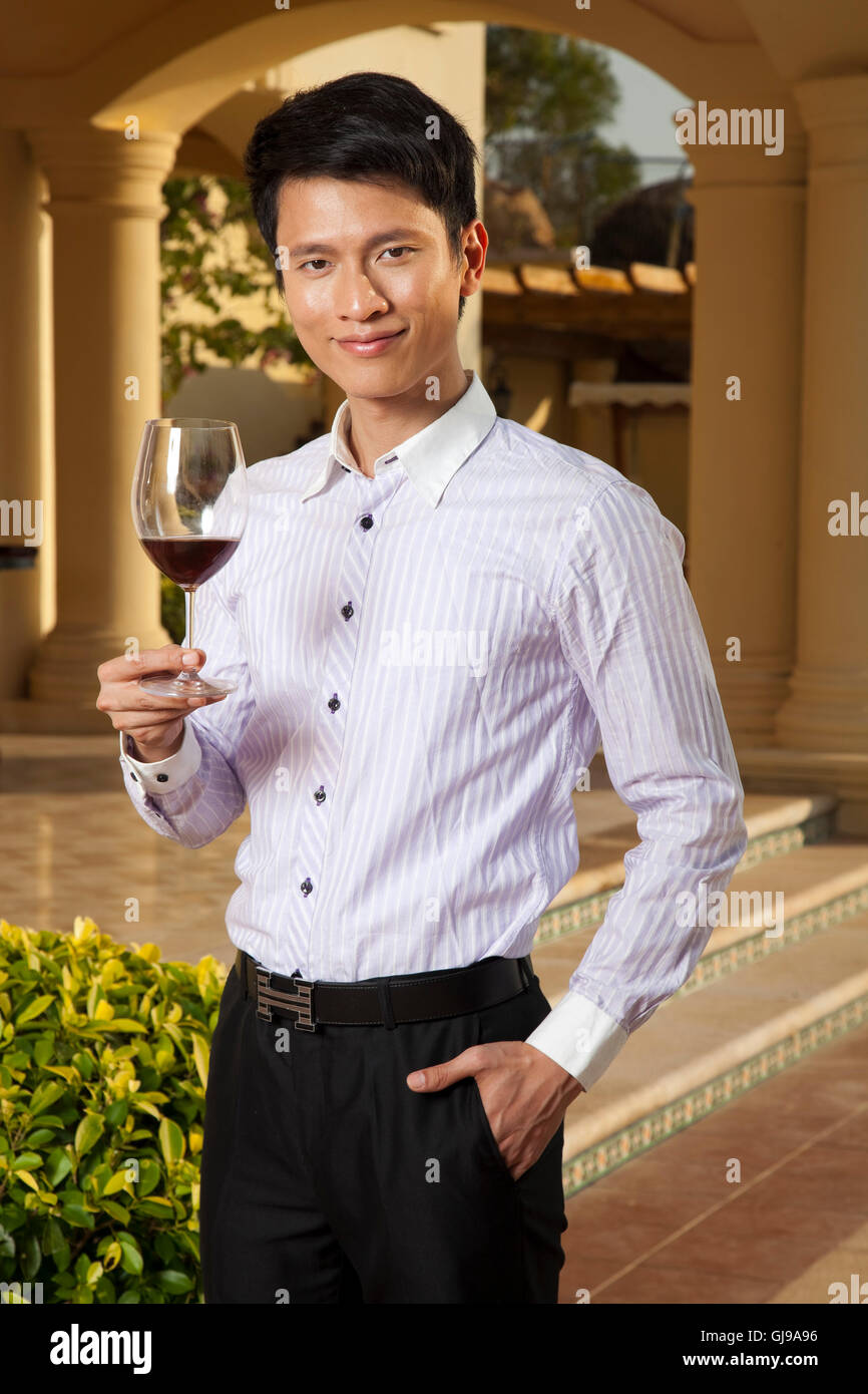 Young men drinking red wine in the hotel Stock Photo - Alamy