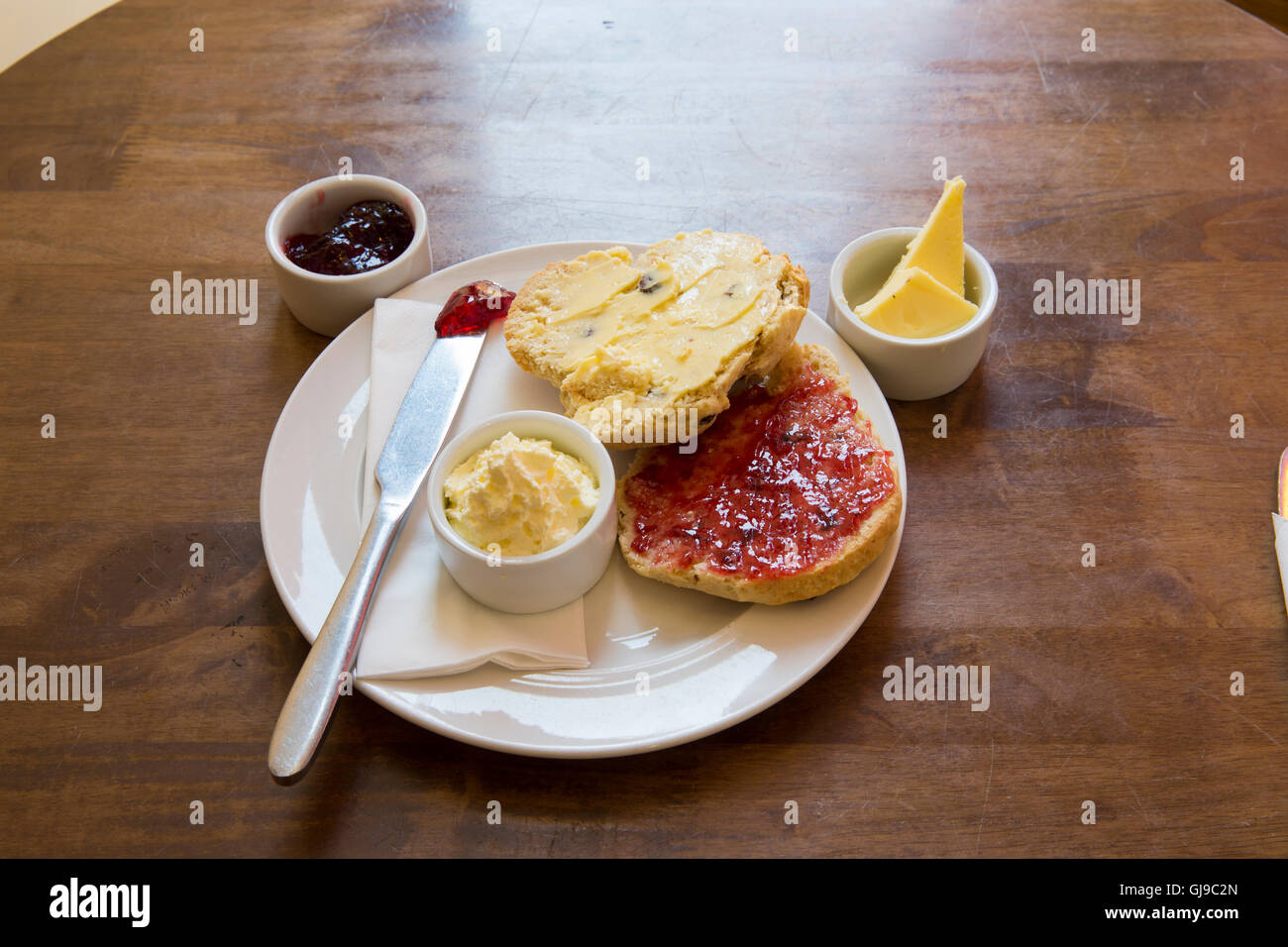 Scone with butter Jam and Cream Stock Photo Alamy