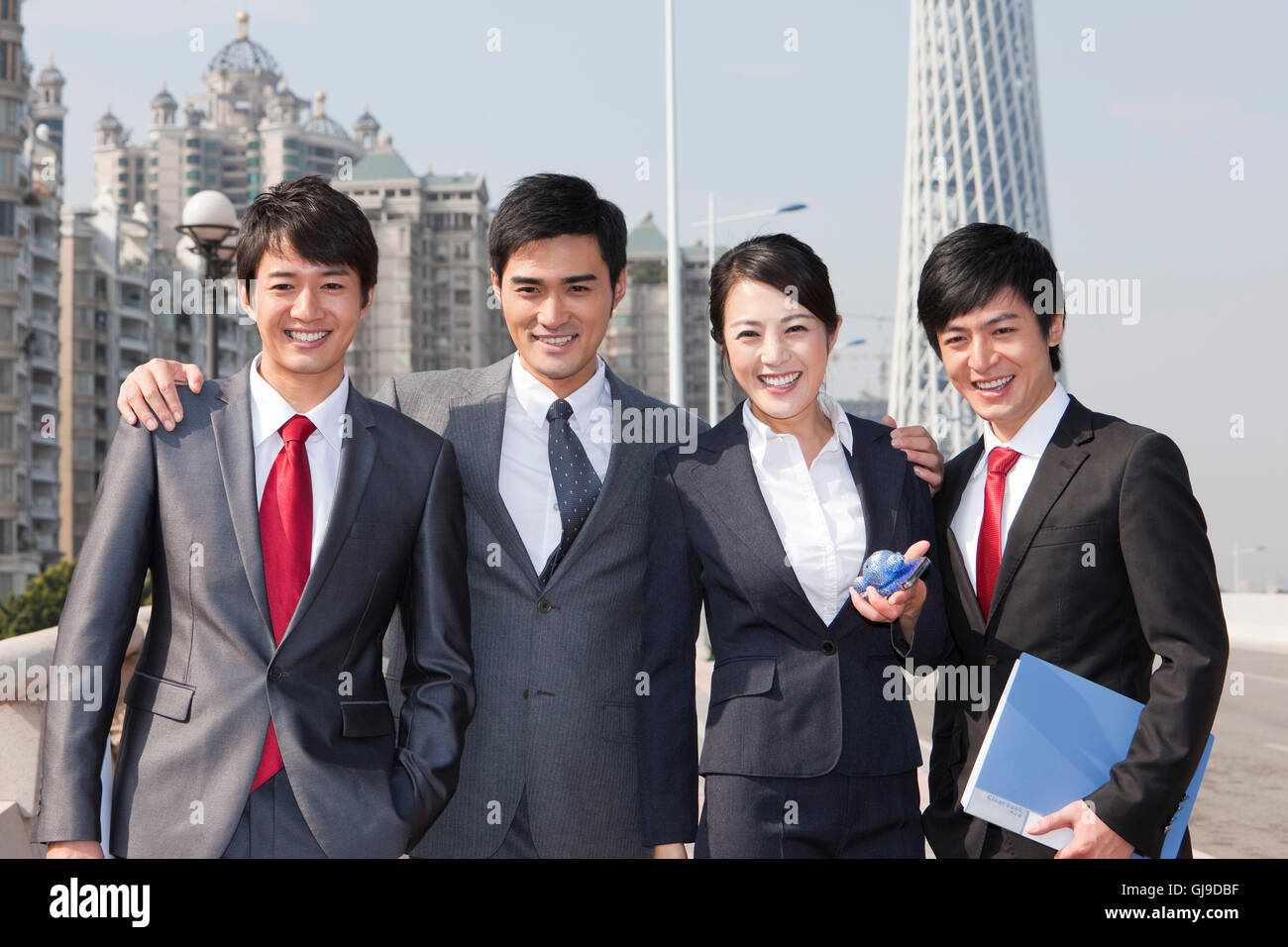 Young men and women in business outside the office building Stock Photo ...