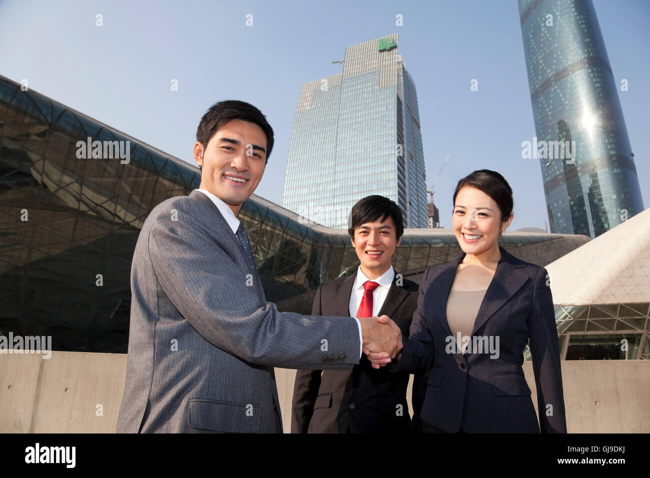 Young men and women in business outside the office building Stock Photo ...