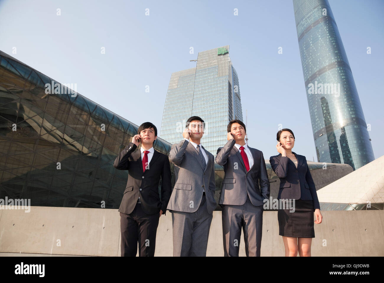 Young men and women in business outside the office building Stock Photo ...