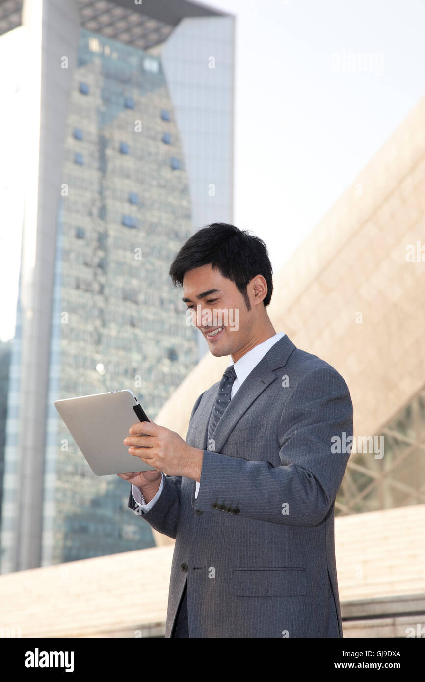 Young business man outside office building Stock Photo - Alamy